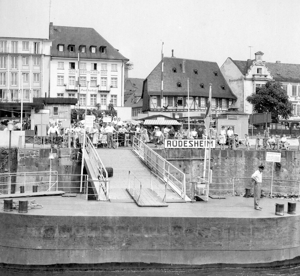 A crowd of people on a large dock. 