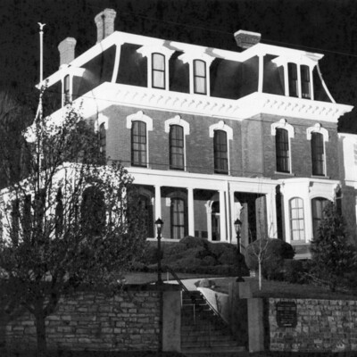 Victorian house lit up at night.