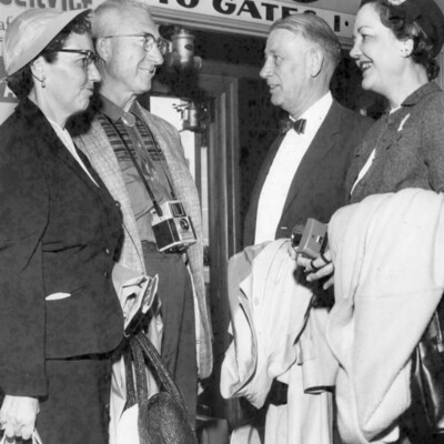 Two couples near an airline gate.