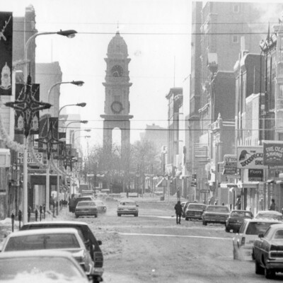 winter view down downtown street toward a clock tower