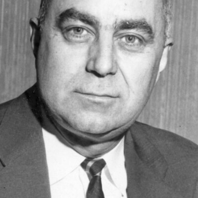 Head shot of man with crew cut, wearing a suit