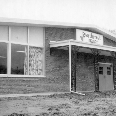 Brick building with large windows.