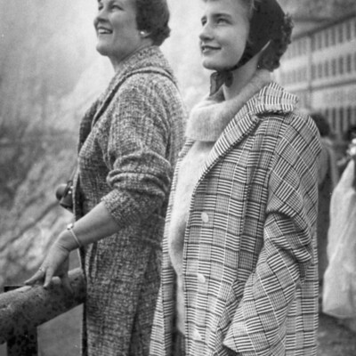 Two smiling women looking upward.