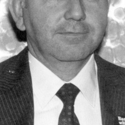 Headshot photo of man in suit and tie