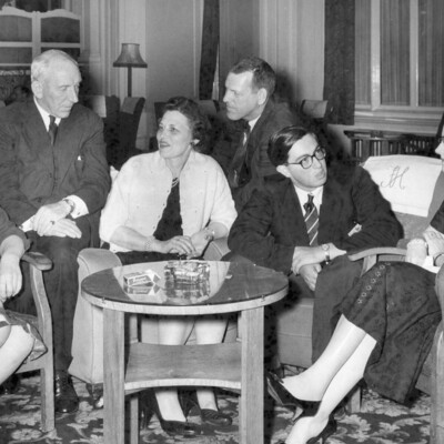 A group of people chatting near a table.