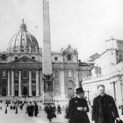 Many people walking in front of St. Peter's Basilica. 