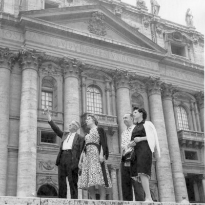Two couples in front of a church.