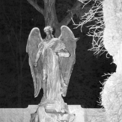 large outdoor state of an angel, lighted against a night sky