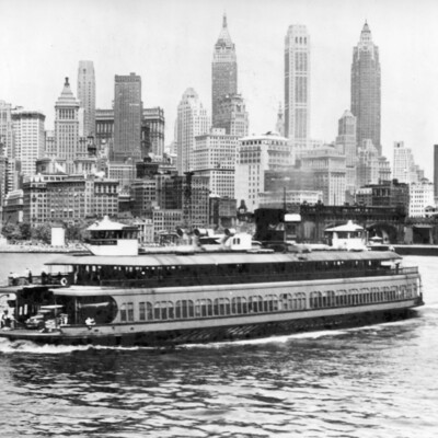Ferry boat in front of a city scape.