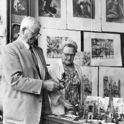 A man and woman viewing items in a shop.