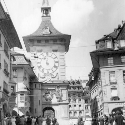 A clocktower on a city street.