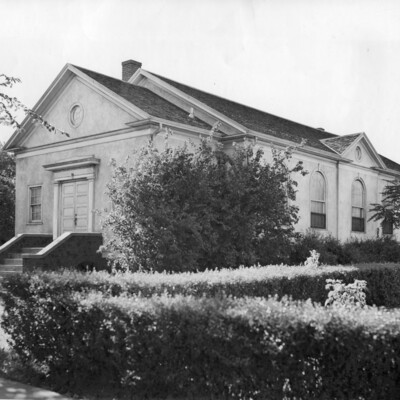 front and side of one-story stucco church building