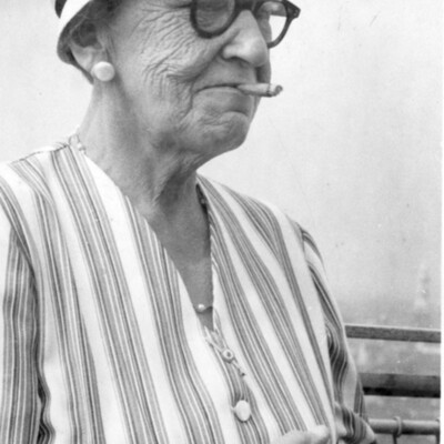 A woman with a cigar in her mouth.