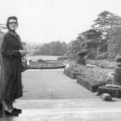 Woman viewing a formal garden.