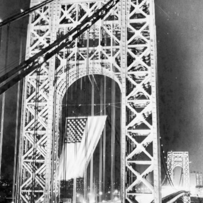 Flag waving on a bridge.