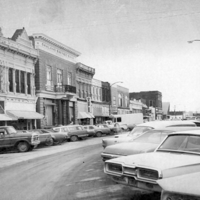 Angle-parked cars next to main street buildings.