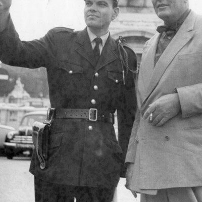 A policeman directing a man on a street.