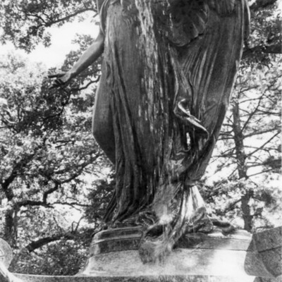 large outdoor state/fountain of an angel, viewed from below.