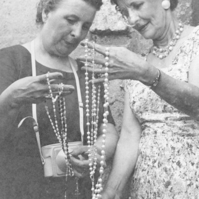 Two women holding rosaries.
