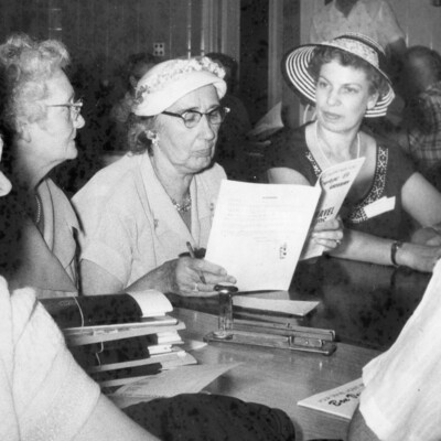 A man and 4 women sitting at a table.