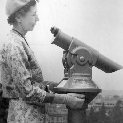 Woman looking at telescope.