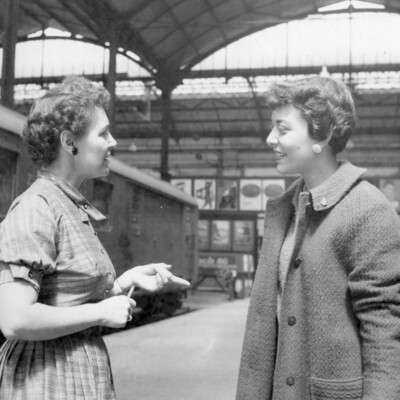 Two women speaking.