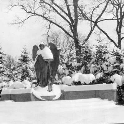 large outdoor statue of an angel covered in snow