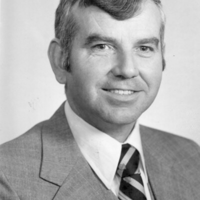 Head shot photo of man in suit and tie