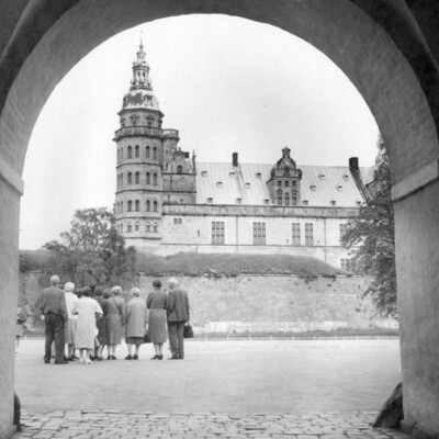 A group of tourist view a castle.