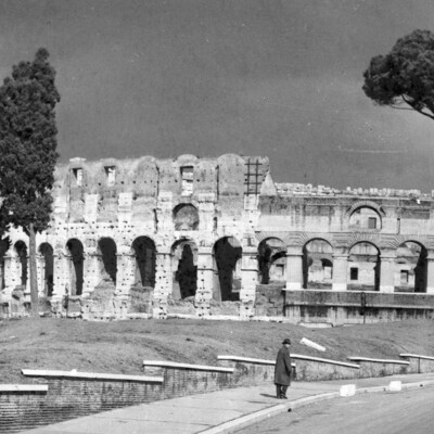 A man walks near the ruins of public baths.