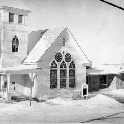 A church building with snow-covered grounds.
