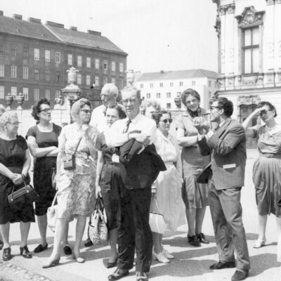 A group of people on a sidewalk.