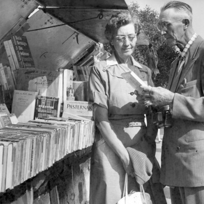 A man and woman looking at books.
