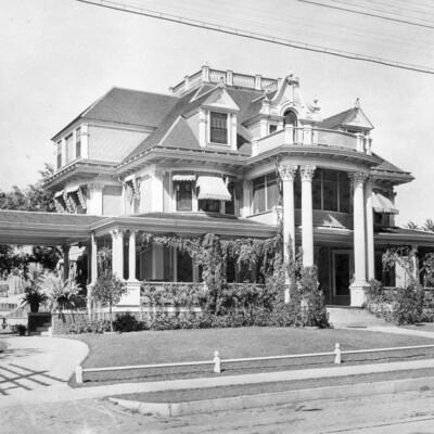 Photo of 3-story mansion with 2-story columns, and a portico