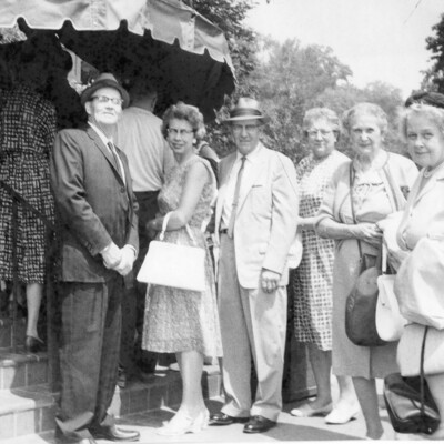 A group of six adults posing for the camera.