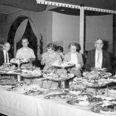 A group of people at a buffet table.