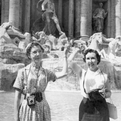 Two women in front of a fountain.
