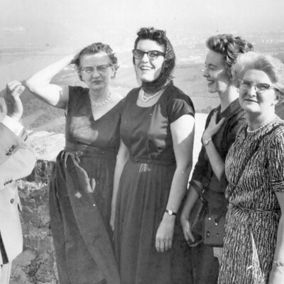 A man and four women on an overlook.