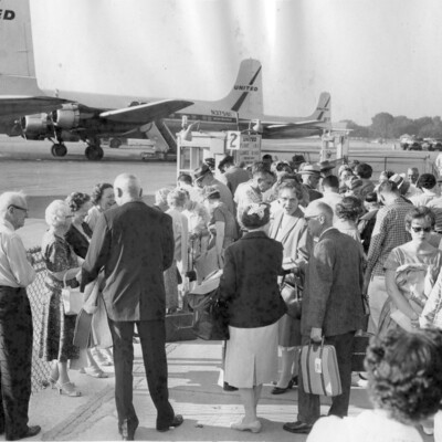 A crowd gathered at an airport gate.