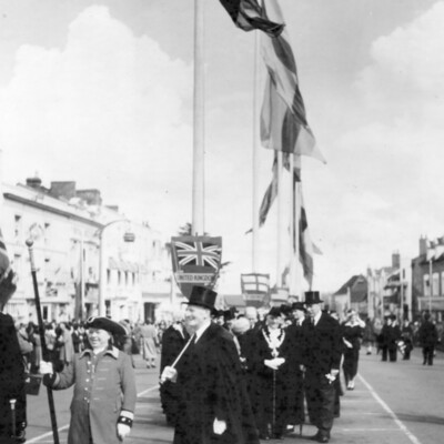 Flags fluttering above a group of men.