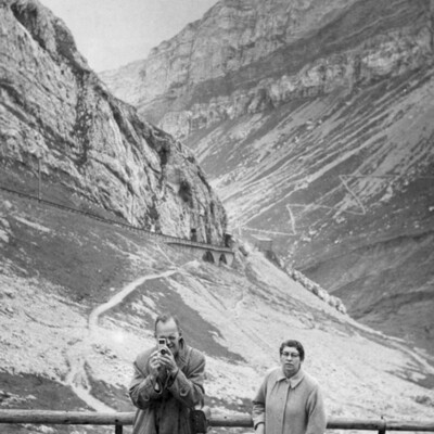 A man and woman with mountains in the background.