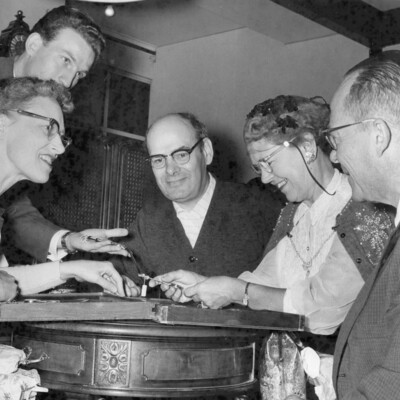 People viewing items on a table.