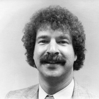 head shot of man with moustache